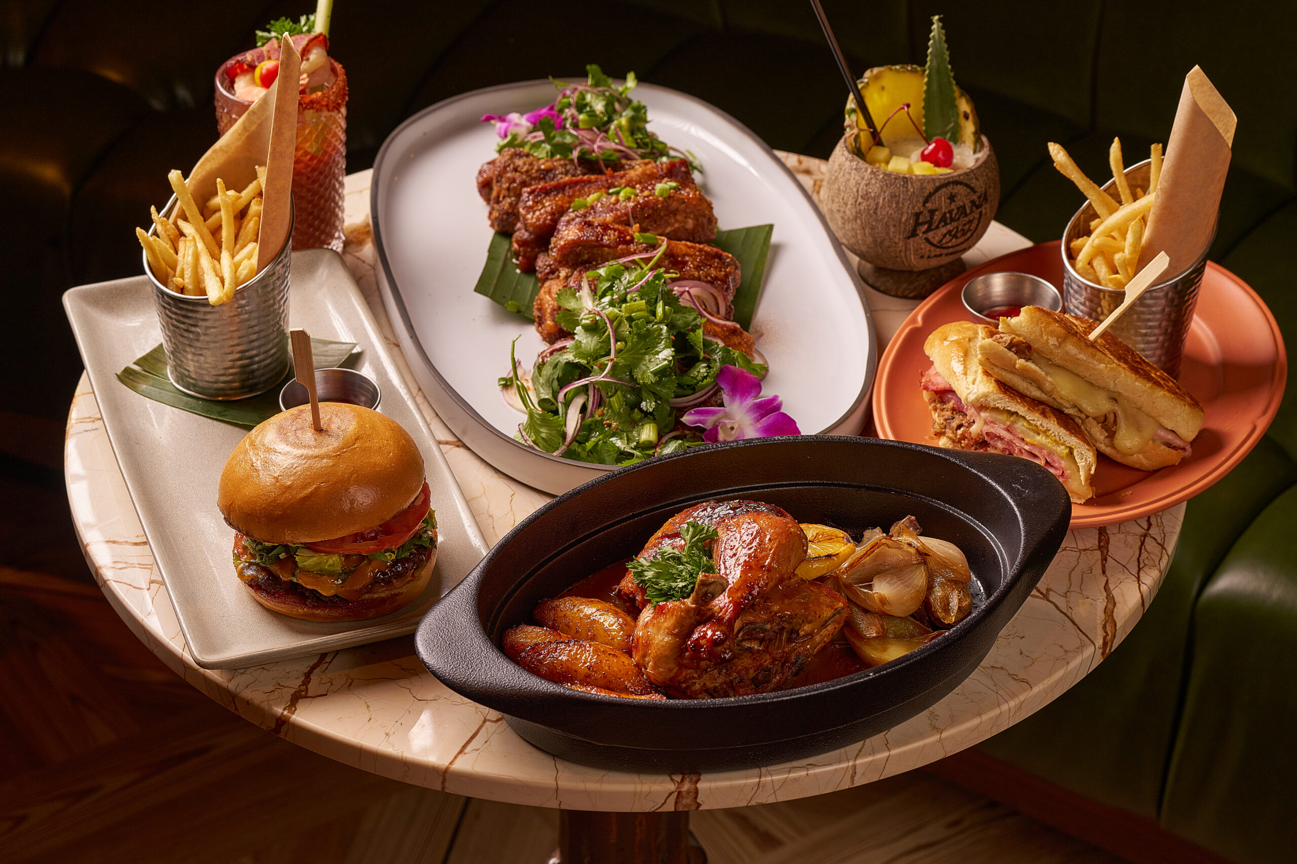 authentic Cuban dishes at Havana 1957 South Beach, featuring roasted chicken, classic Cuban sandwich, and tropical cocktails